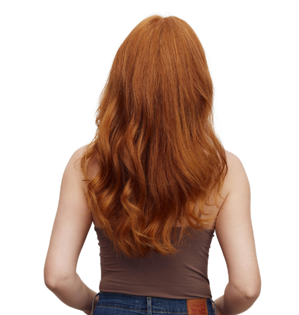 Client with vibrant copper hair color styled at Harmony Hair Studio